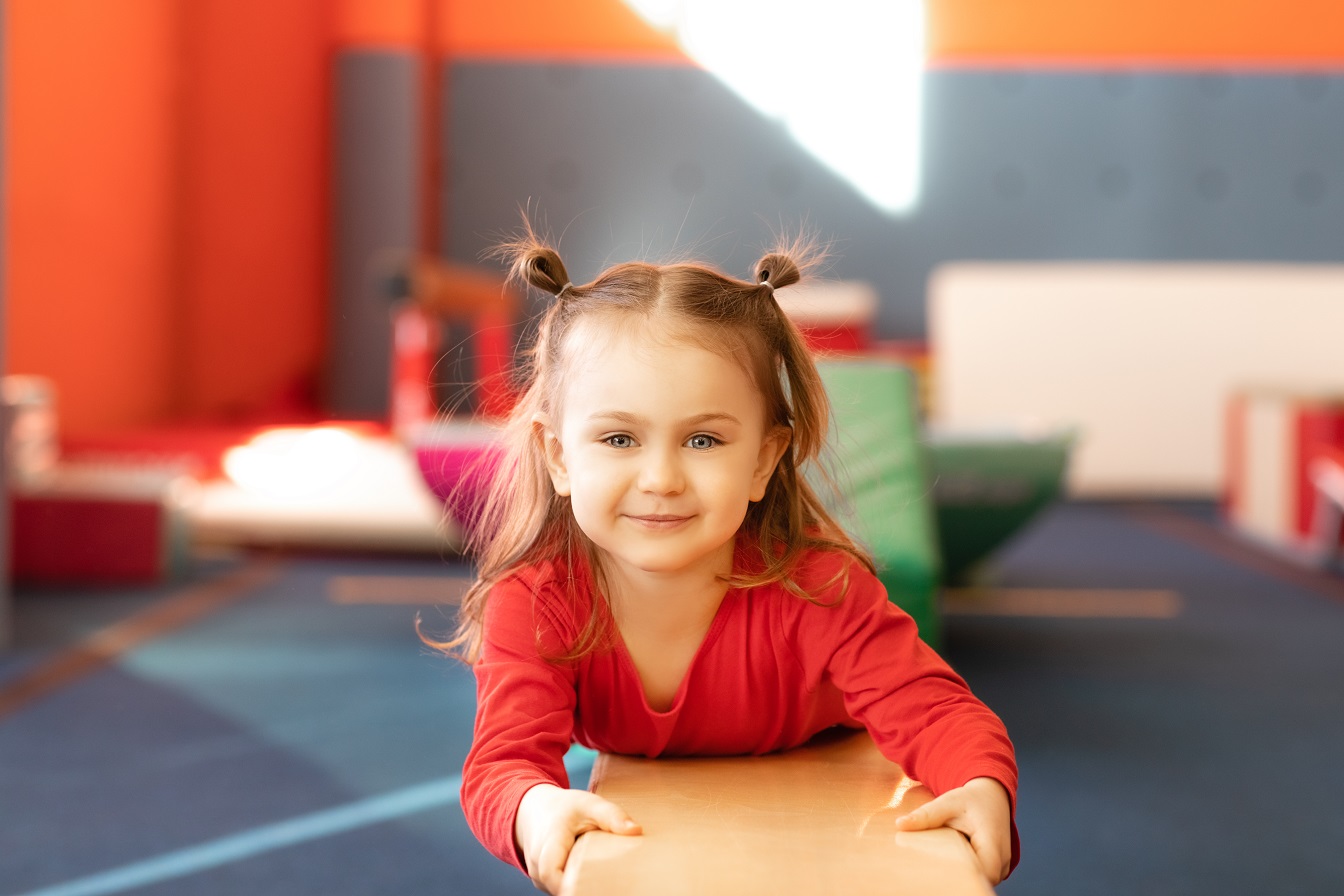 Cute active child girl in sensory integration room, kindergarten. Kid is active leisure.Childhood and sporty lifestyle.Sports weekend in gymnastic center.Fitness,healthy, develop skills concept